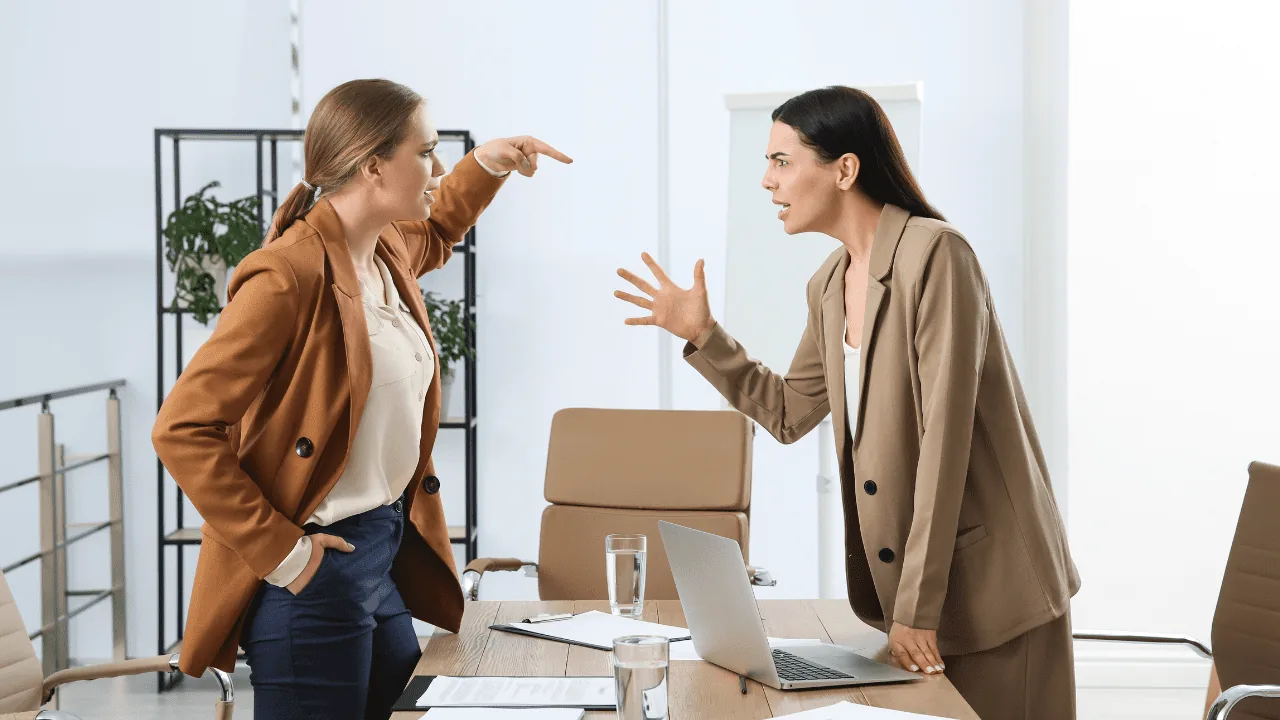 Two women in a heated argument demonstrating emotional reactivity, highlighting the need for neuroscience-based life coaching