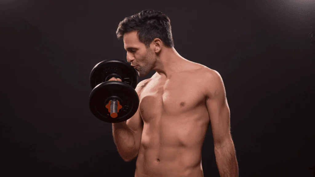 A man lifting weights who is kissing the dumb bell proving he is a narcissist.