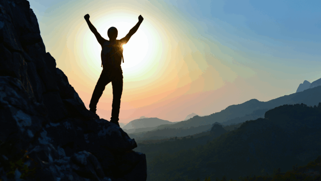 Mountain climber reaching a summit, representing trust and resilience under pressure