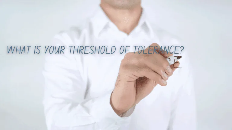 A man writing 'What is your threshold of tolerance?' to introduce the concept of emotional regulation in neuroscience.