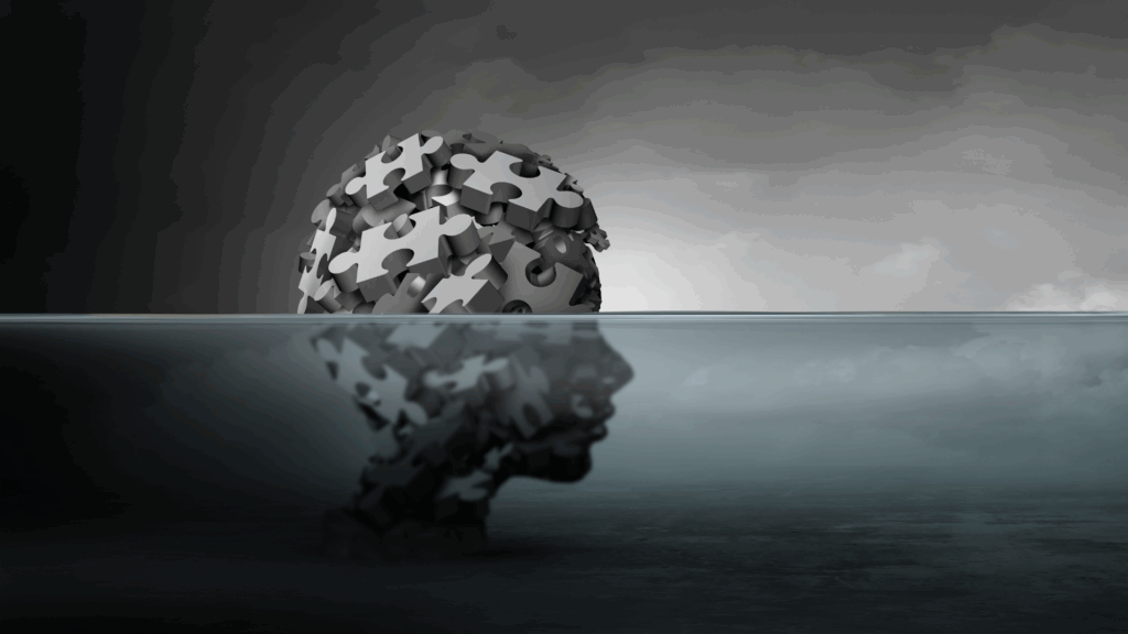 Half-submerged puzzle piece head in water, representing fragmented identity