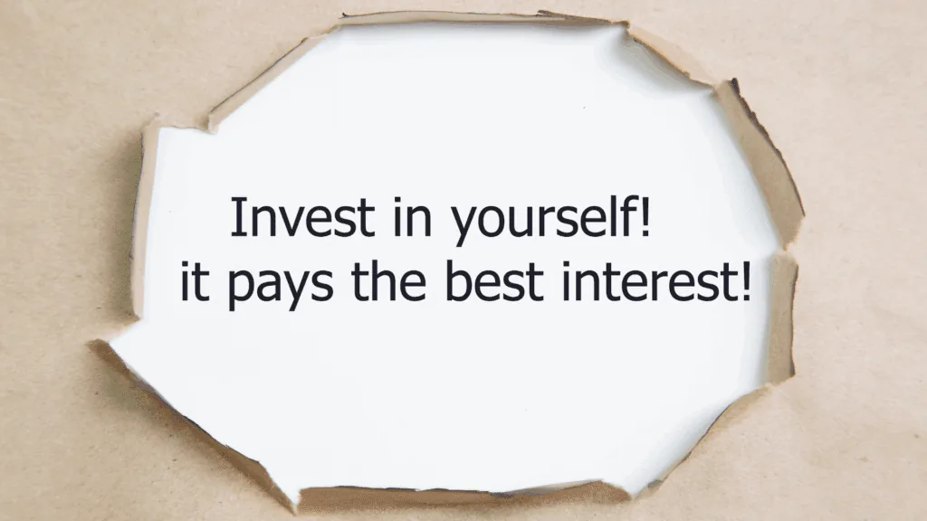 Motivational quote about self-investment through torn paper
