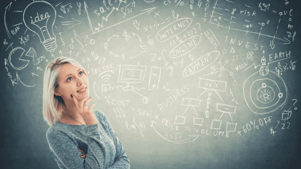 A person visualizing ideas with business concepts sketched on a chalkboard.