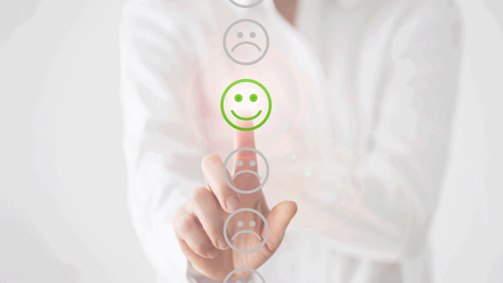 Person selecting a green smiley face on a virtual interface, representing positive emotional rewiring through neuroplastic momentum.