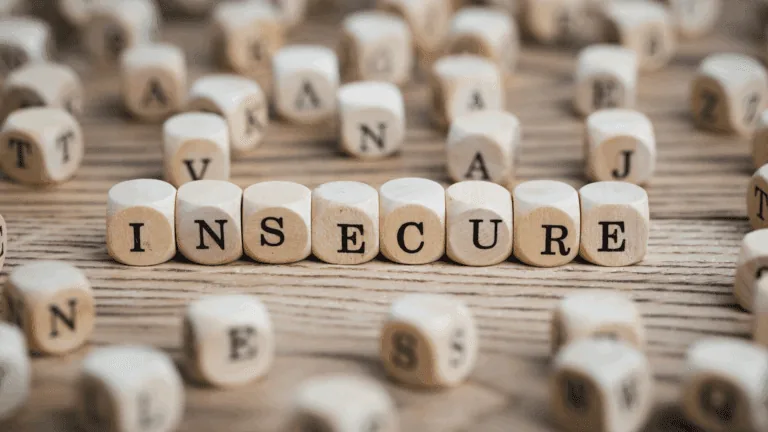 Wooden blocks spelling insecure, representing the neuroscience of insecurity