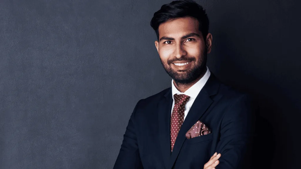 Confident person in a dark suit, representing composure and professional presence.