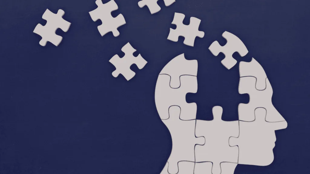 A human head made of puzzle pieces representing interconnected neural networks.