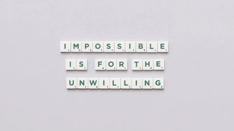 Scrabble tiles spelling “Impossible is for the unwilling” representing mindset mastery