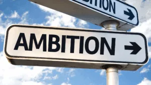 Street sign with the word ambition, symbolizing the choice to escape hustle culture and redefine success.