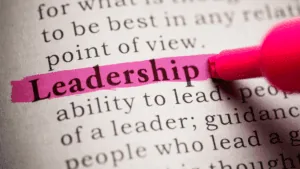 Close-up of the word leadership highlighted in pink, symbolizing the importance of leadership presence.