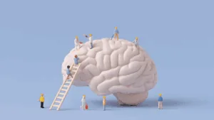 Miniature workers building a human brain model, symbolizing the neuroscience of micro-changes in personal growth.