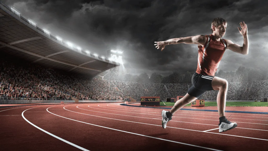 Track athlete sprinting focused on peak performance through neuroscience of performance coaching methods.