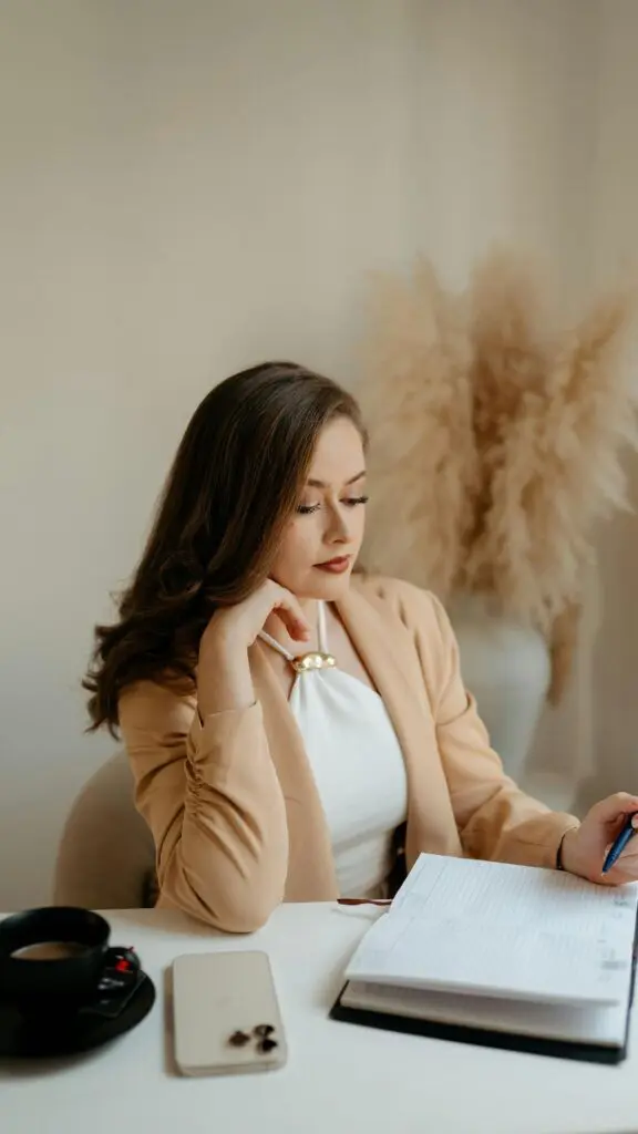 Professional seated in a modern workspace, thoughtfully reviewing notes, reflecting the cognitive focus enabled by brain neuroplasticity.