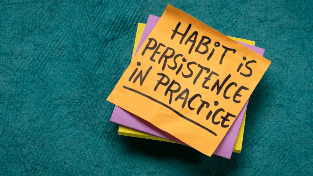 A sticky note reading Habit Is Persistence In Practice, symbolizing routines that retrain compulsive patterns.