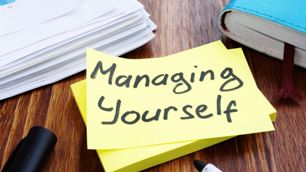 A sticky note reading Managing Yourself beside a planner, symbolizing routines that support self-regulation.