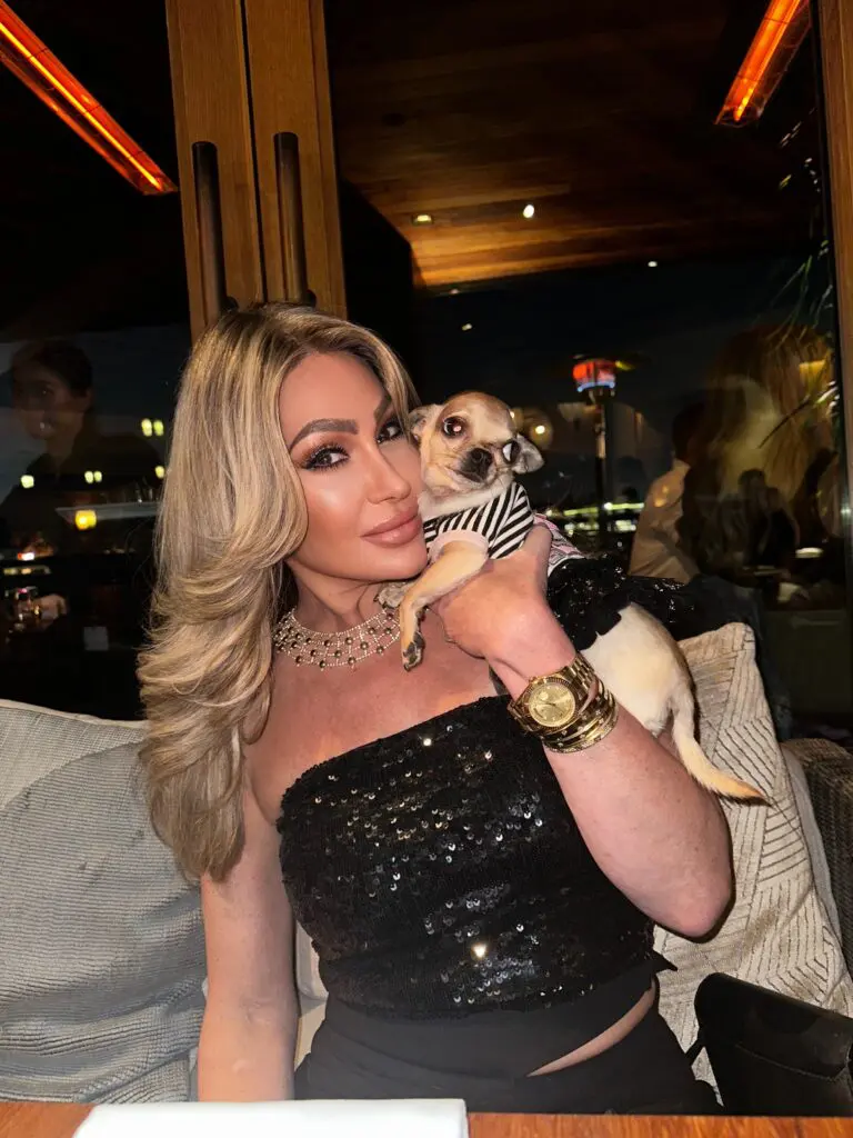 Dr. Sydney Ceruto with her dog Lola at dinner, showing authentic personal connection
