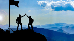 "Two men celebrating personal growth and goal achievement through life coaching on a mountain summit. Keywords: Personal growth life coaching, Enhancing self-awareness life coaching, Brain-based coaching emotional health."