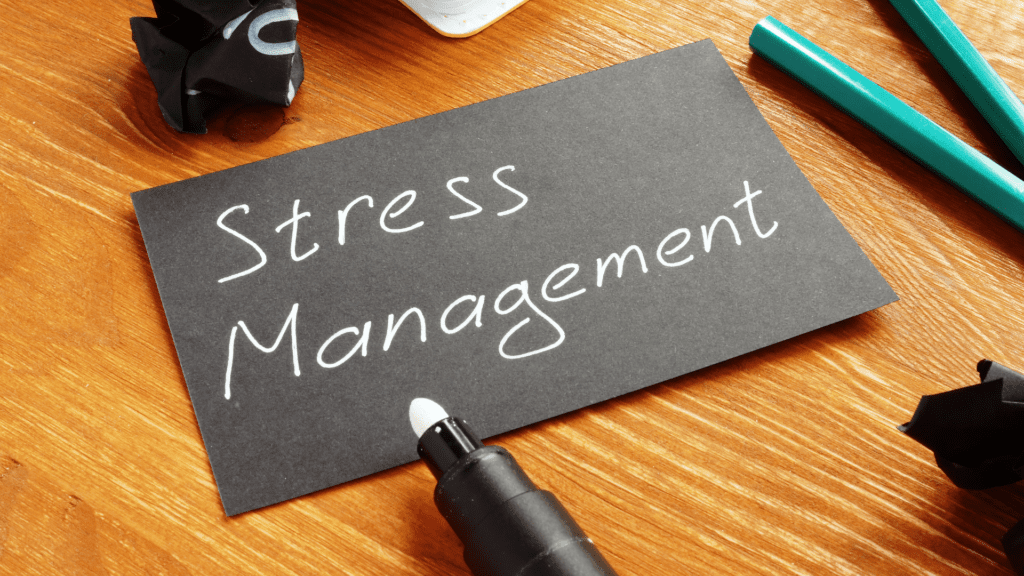 Stress management written on a black card