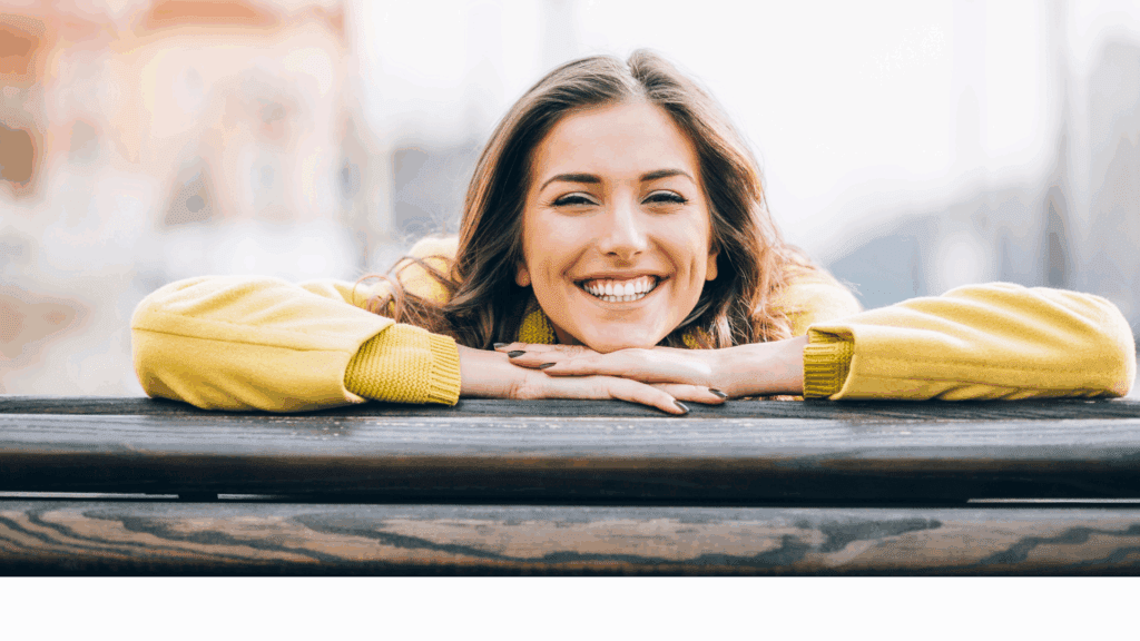 a picture of a woman smiling brightly because she is happy