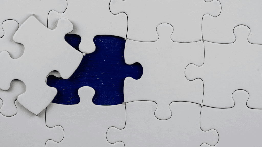 Close-up of a puzzle with one missing piece, symbolizing the link between brain regions and cognitive biases.