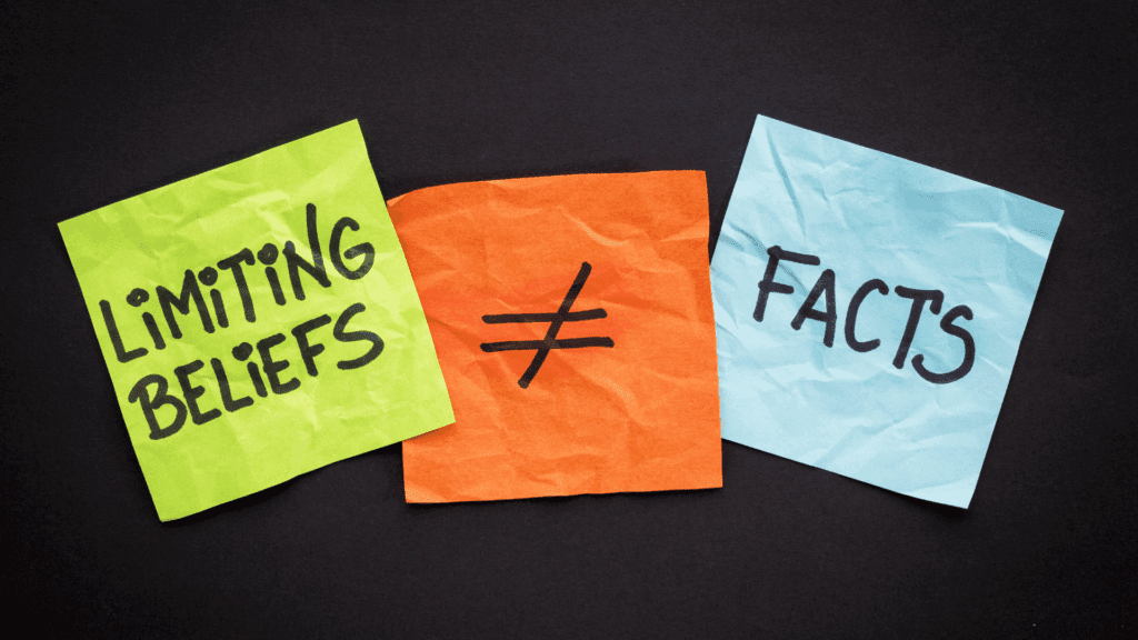 Sticky notes showing “Limiting Beliefs ≠ Facts,” symbolizing overcoming limiting beliefs.
