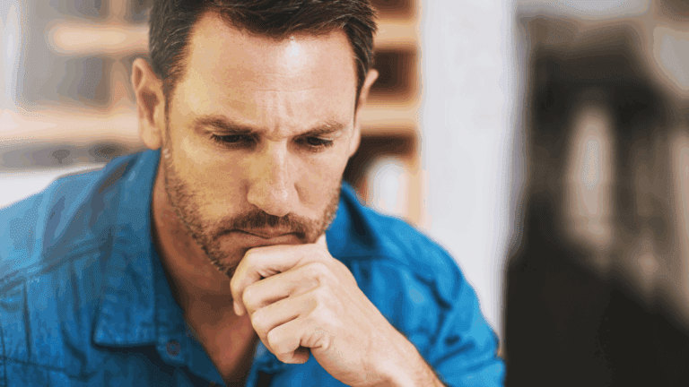 Man experiencing mental blocks while deep in thought.