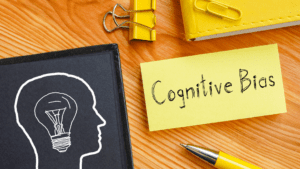 Sticky note with Cognitive Bias text, relating to optimism and cognitive ability