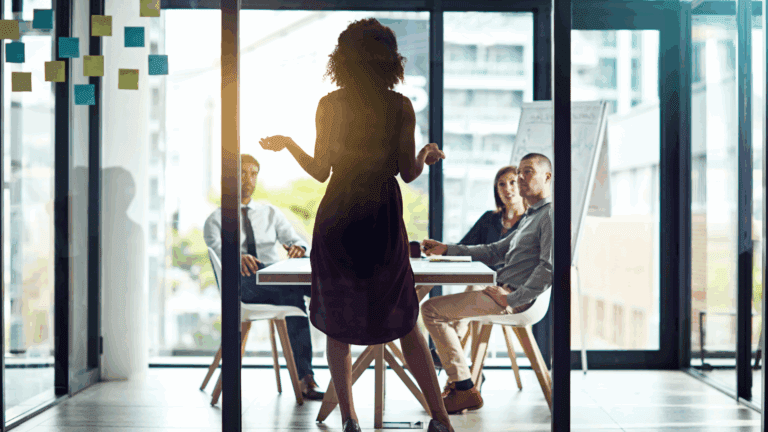 a woman standing in front of a group of people showing leadership resilience