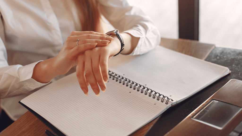a woman's hands on a notebook aiming for productivity