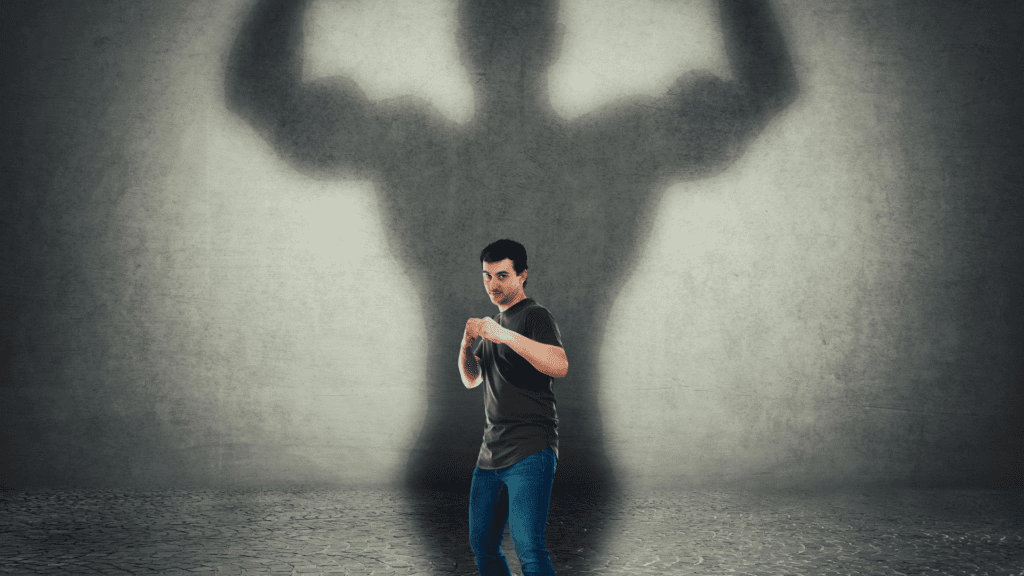 a man standing in front of a shadow of a man depicting how to stay motivated