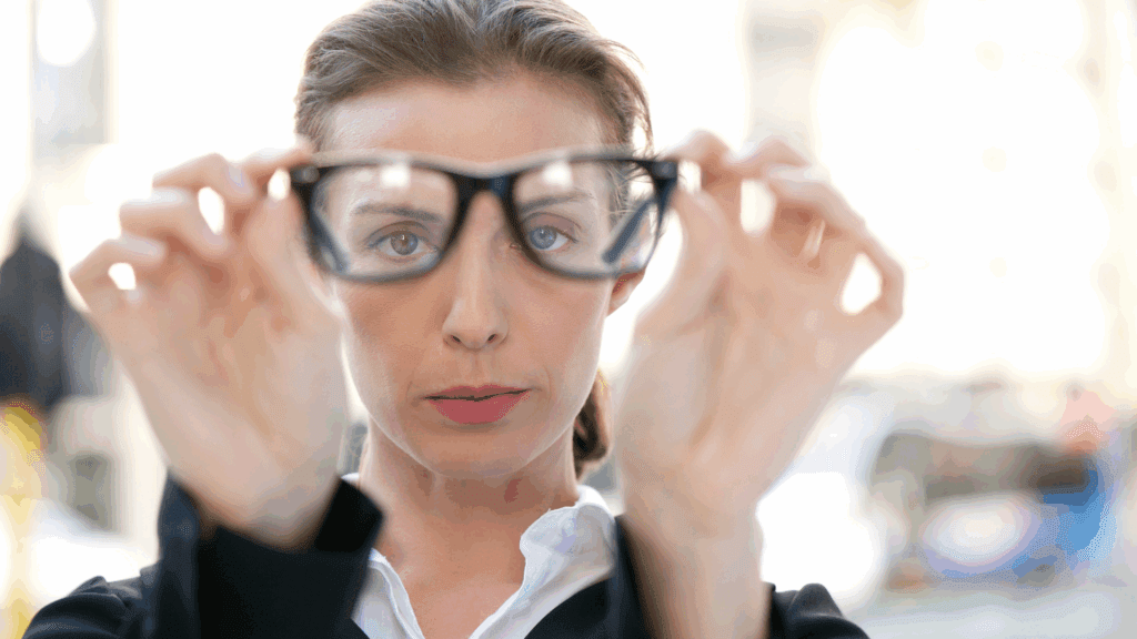 Woman adjusting her glasses, focusing on changing perspective.