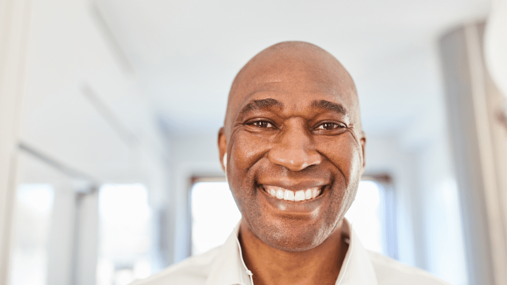 Smiling man in a white shirt demonstrating likeability.

 