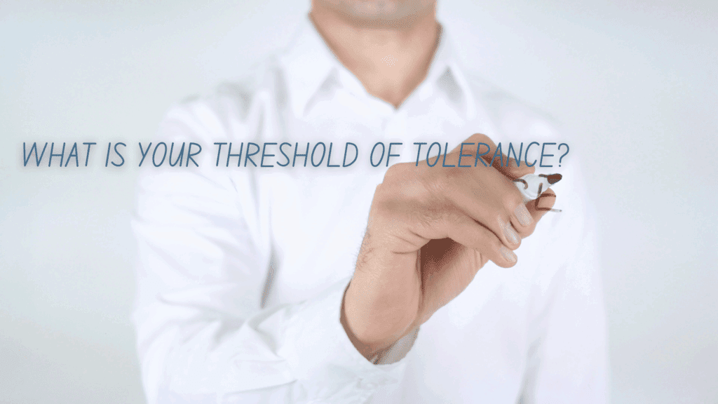 A man writing 'What is your threshold of tolerance?' to introduce the concept of emotional regulation in neuroscience.