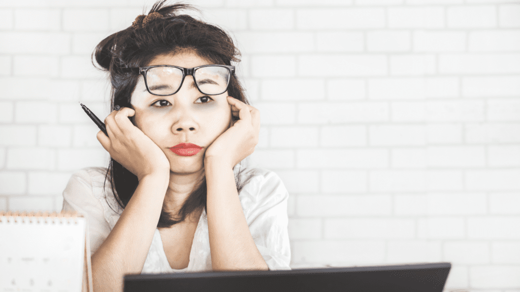 asian professional experiencing workplace mental fatigue at desk


