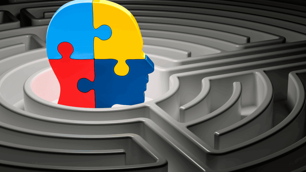 A colorful puzzle piece in the shape of a human head, placed in the center of a labyrinth, symbolizing mental challenges.
