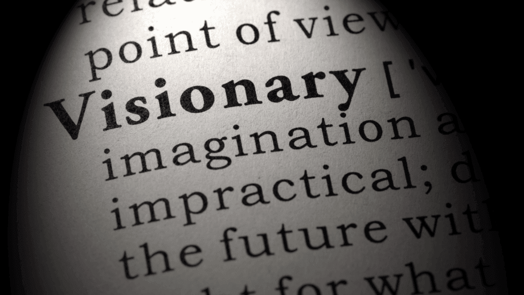 Close-up of the word visionary  in a dictionary, symbolizing the essence of a visionary mindset.

