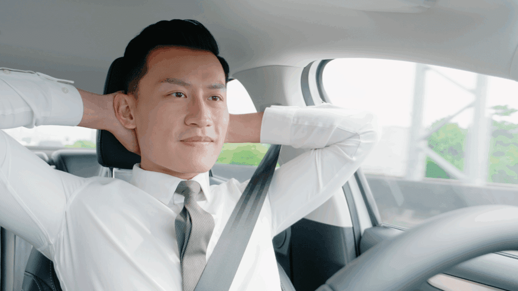A man relaxing in his car on autopilot, signifying the comfort of routines but also the need for intentional engagement.