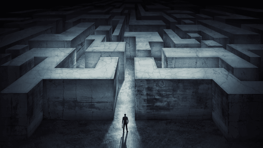 Person standing at the entrance of a dark, complex maze symbolizing the counterintuitiveness of the brain and navigating subconscious challenges.







