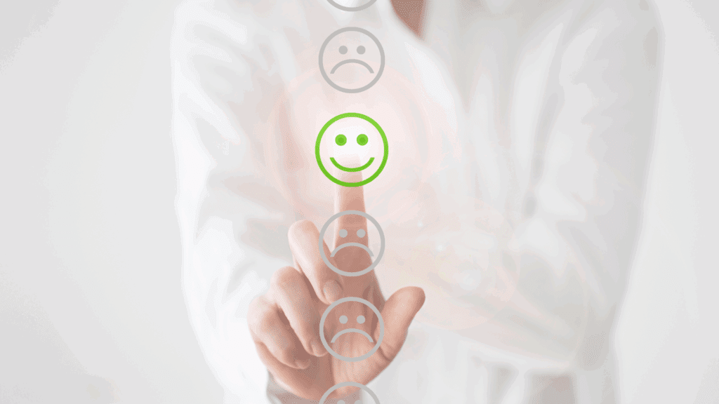 Person selecting a green smiley face on a virtual interface, representing positive emotional rewiring through neuroplastic momentum.




