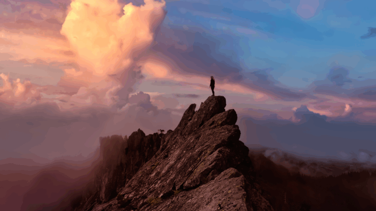 Person standing on a mountain peak at sunrise, representing a success-focused mindset and achieving goals. .