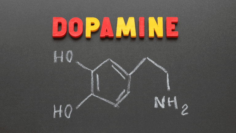 Dopamine addiction: Molecular structure of dopamine drawn on chalkboard.