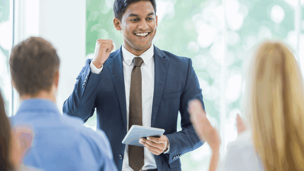 A confident professional celebrating success in a meeting, illustrating the impact of dopamine boosting foods on motivation.