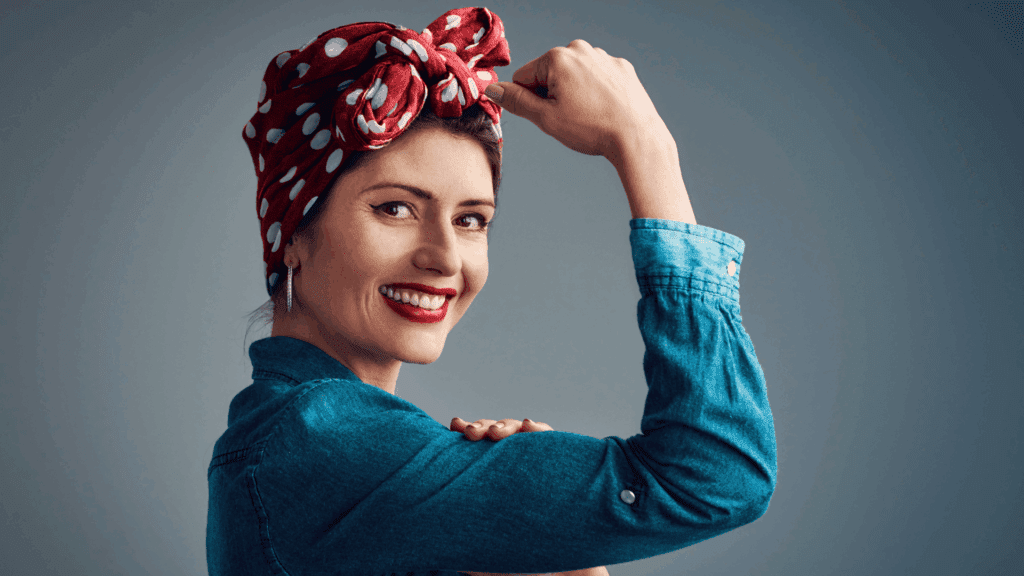 A person in a denim shirt flexing their arm, symbolizing hyper independence and inner strength.