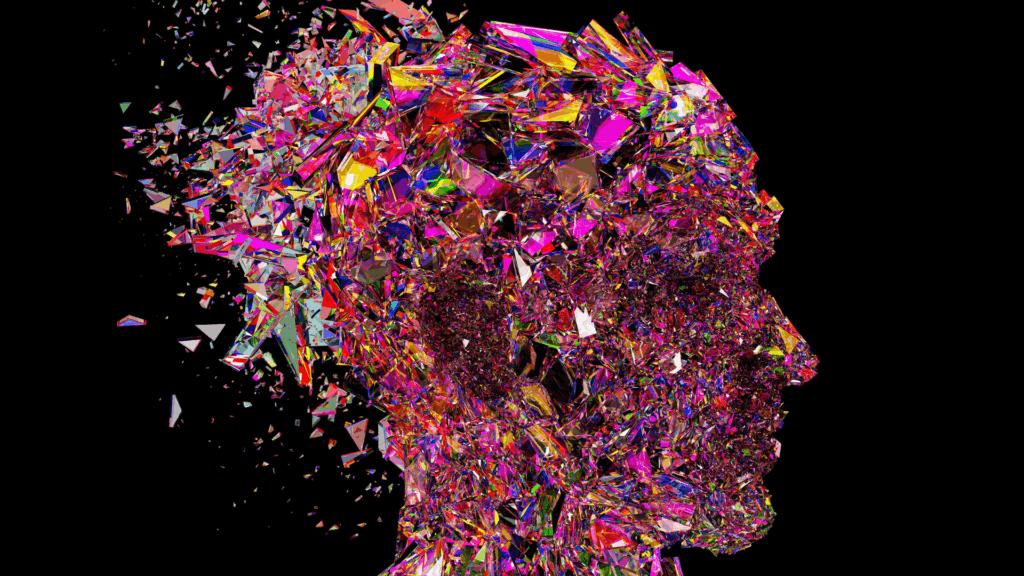 Colorful abstract head made of glass shards symbolizing neuroplasticity coaching and change.