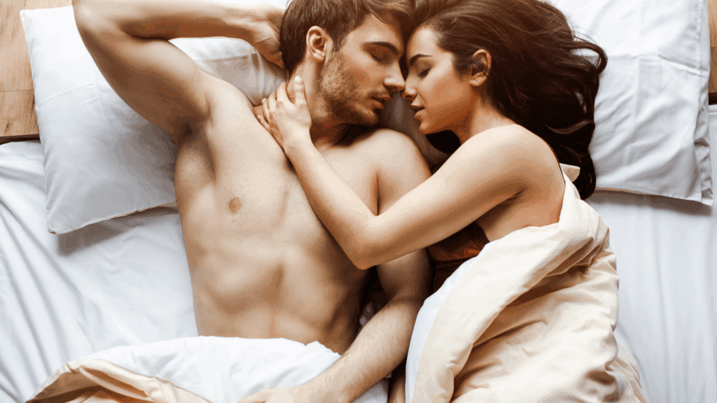 Aman and woman holding one another in bed representing the neuroscience of sex addiction.