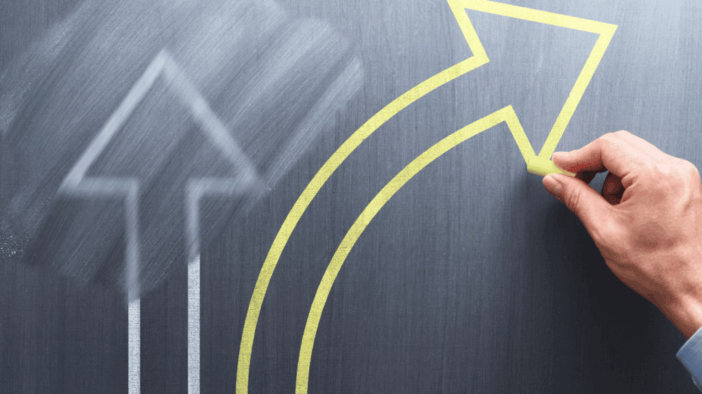 Hand drawing an upward arrow to illustrate progress from resistance to change to readiness for change.