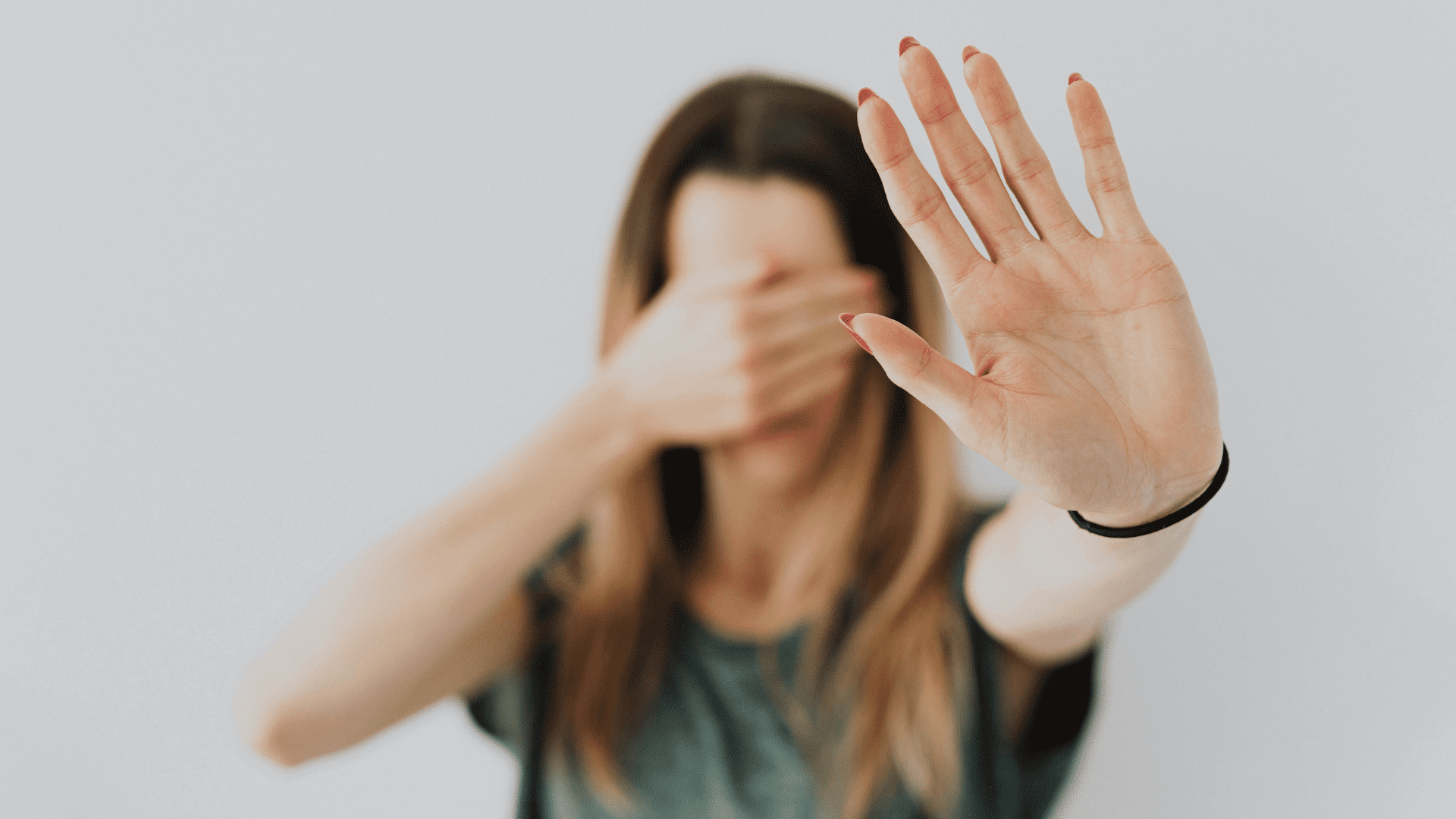 Person holding up a hand in a stop gesture, reflecting resistance to change and readiness for change.
