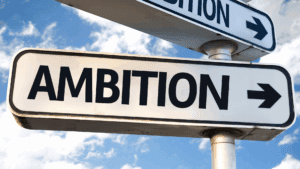 Street sign with the word ambition, symbolizing the choice to escape hustle culture and redefine success.