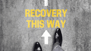 Feet standing before the words “Recovery This Way,” symbolizing guidance on how do I stop a panic attack.