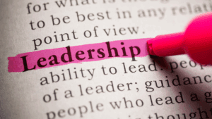 Close-up of the word leadership highlighted in pink, symbolizing the importance of leadership presence.
